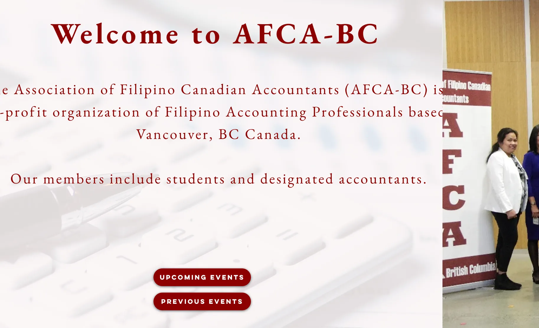 An early redesign direction for the AFCA-BC homepage: a serif maroon 'Welcome to AFCA-BC' headline over a light keyboard-and-pen photo background, a real event photo, and two maroon pill buttons.
