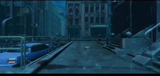 In-engine environment shot: a moody blue-lit city street at night, with parked cars, brick buildings, and a figure visible in the distance.